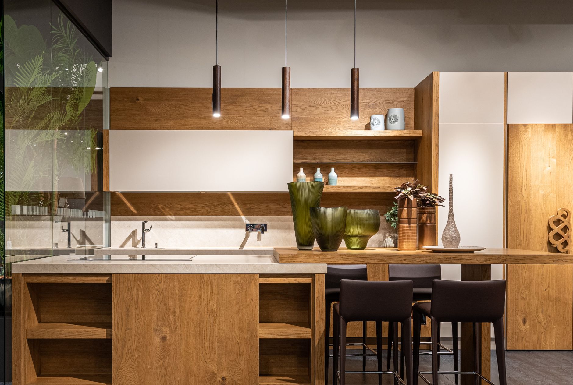 A tidy kitchen counter with a short row of small household items lined up like dominoes